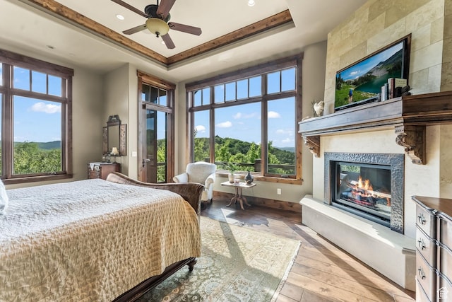 1355 W Red Hawk Trl Unit 35, Park City, UT 84098 - bedroom with a fireplace, a raised ceiling, ceiling fan, wood finished floors, and baseboards
