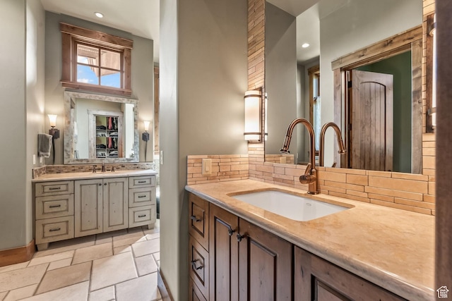 1355 W Red Hawk Trl Unit 35, Park City, UT 84098 - bathroom featuring stone tile floors, two vanities, tasteful backsplash, and a sink