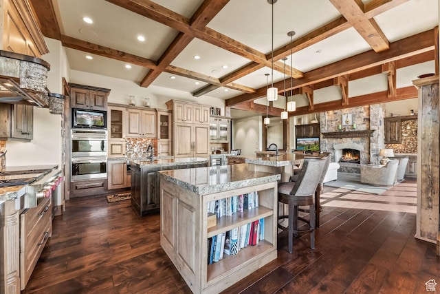 1355 W Red Hawk Trl Unit 35, Park City, UT 84098 - kitchen with coffered ceiling, a large island, appliances with stainless steel finishes, a breakfast bar, and dark wood-style flooring