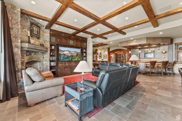 1355 W Red Hawk Trl Unit 35, Park City, UT 84098 - living area featuring stone tile floors, arched walkways, coffered ceiling, a stone fireplace, and beam ceiling