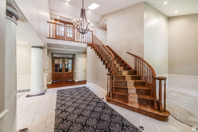 1387 E 260 N, Logan, UT 84321 - foyer entrance with decorative columns, a towering ceiling, light tile patterned floors, and a notable chandelier