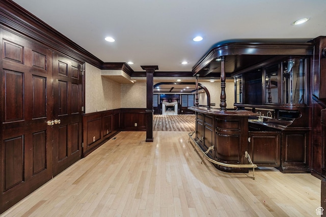 1387 E 260 N, Logan, UT 84321 - bar featuring decorative columns, dark brown cabinetry, crown molding, and light wood-type flooring
