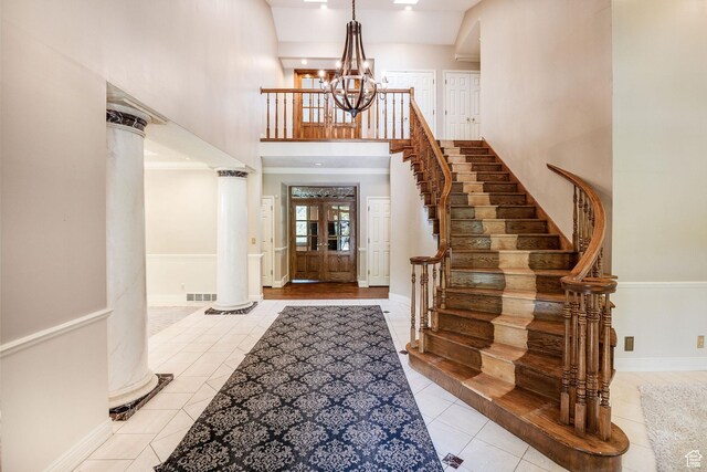 1387 E 260 N, Logan, UT 84321 - tiled foyer with ornate columns, french doors, a towering ceiling, and an inviting chandelier