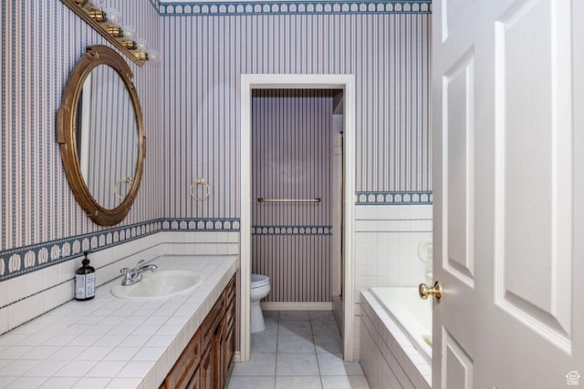 1387 E 260 N, Logan, UT 84321 - bathroom featuring tile patterned flooring, vanity, a relaxing tiled tub, and toilet
