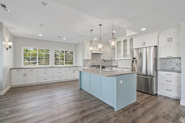 3128 E Hunters Ridge Way, Heber City, UT 84032 - kitchen featuring stainless steel refrigerator with ice dispenser, white cabinetry, dark wood-style floors, decorative backsplash, and light stone countertops
