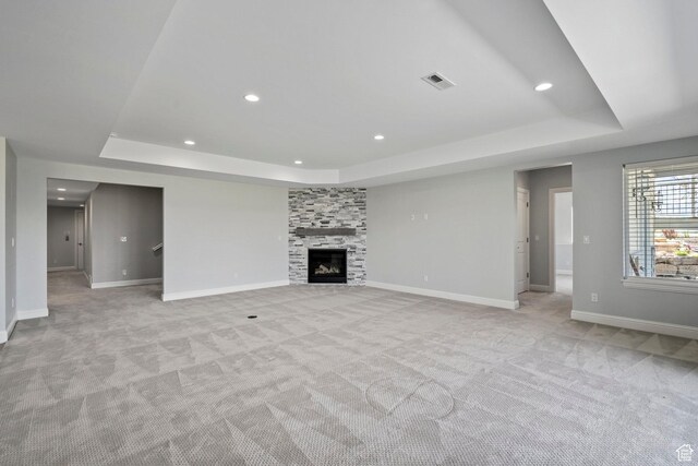 3128 E Hunters Ridge Way, Heber City, UT 84032 - unfurnished living room with a raised ceiling, light carpet, baseboards, recessed lighting, and a tiled fireplace