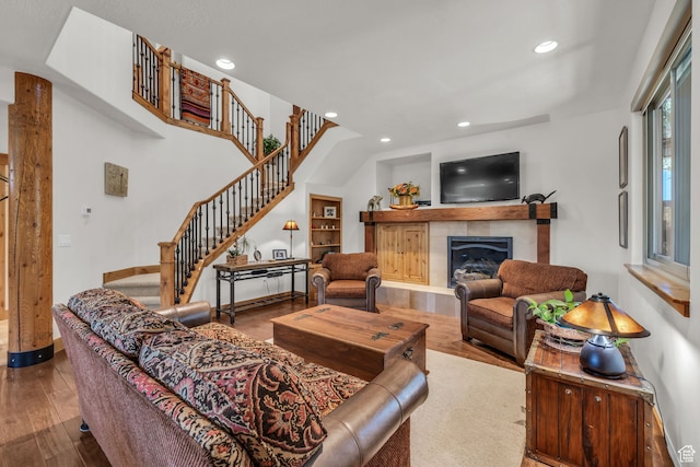 1126 Station Loop Rd, Park City, UT 84098 - living room featuring wood-type flooring, built in features, and a tiled fireplace