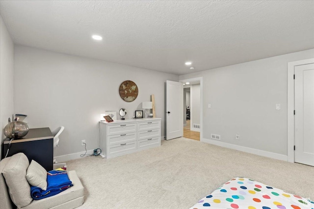 interior space featuring light carpet and a textured ceiling
