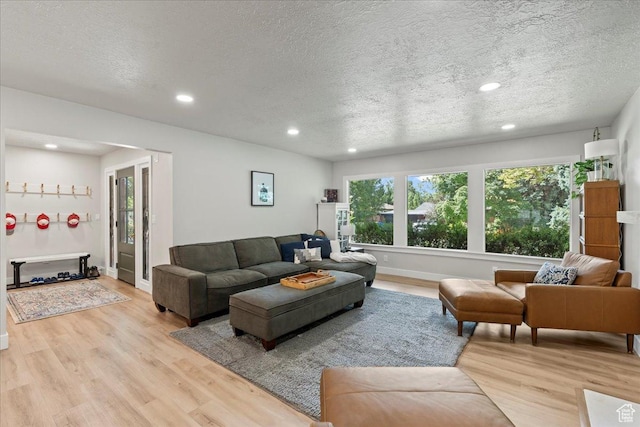 living room featuring a textured ceiling and light hardwood / wood-style flooring