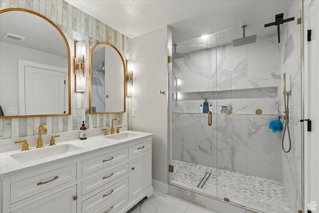 bathroom with vanity, a textured ceiling, and walk in shower