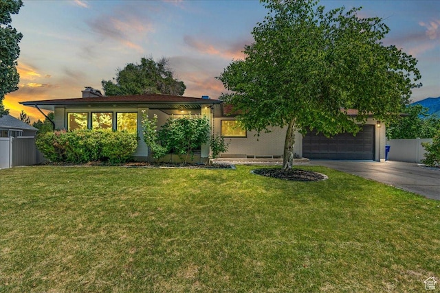 view of front facade featuring a garage and a lawn