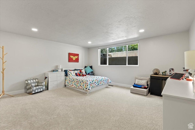 carpeted bedroom featuring a textured ceiling