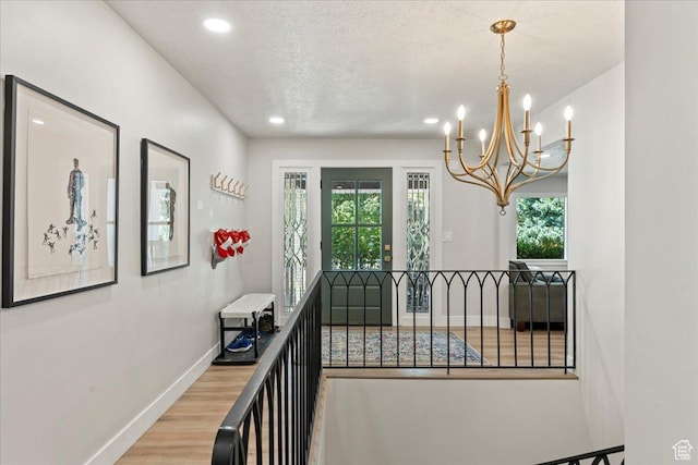 hall featuring hardwood / wood-style floors and a textured ceiling