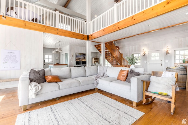 living room with high vaulted ceiling and hardwood / wood-style flooring