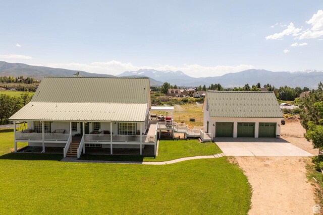 1380 S Mills Ln, Heber City, UT 84032 - view of front facade featuring a mountain view, a front yard, a garage, metal roof, and a porch