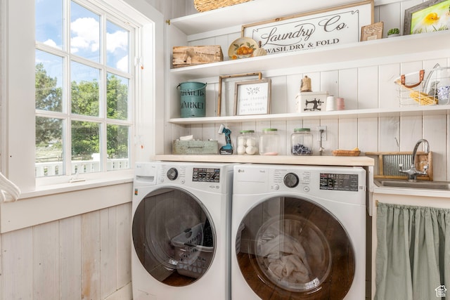 laundry room with independent washer and dryer and sink
