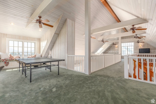 game room featuring beamed ceiling, plenty of natural light, ceiling fan, and carpet