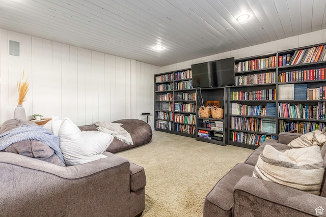 sitting room with wooden ceiling and carpet floors