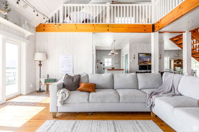 living room featuring a wealth of natural light, hardwood / wood-style floors, and a towering ceiling