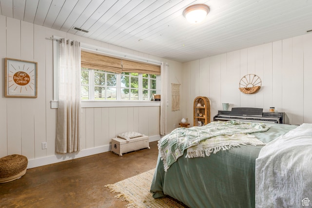 bedroom featuring concrete flooring