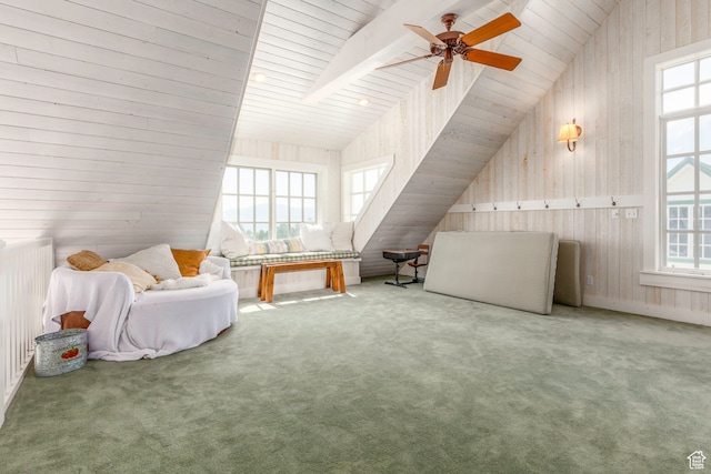 bonus room with carpet floors, plenty of natural light, wooden walls, and ceiling fan