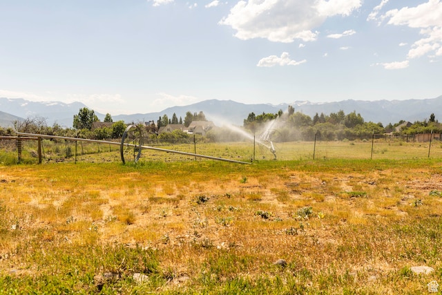 view of yard featuring a rural view and a mountain view
