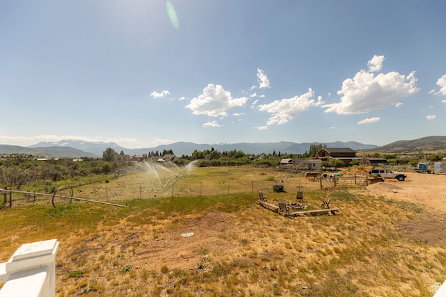 view of yard featuring a rural view and a mountain view