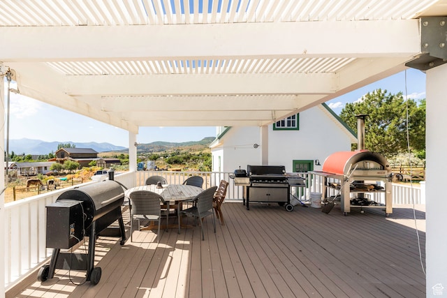 wooden terrace featuring area for grilling, a pergola, and a mountain view