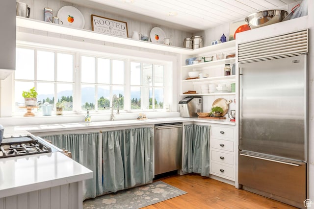 1380 S Mills Ln, Heber City, UT 84032 - kitchen featuring appliances with stainless steel finishes, light countertops, light wood-type flooring, open shelves, and a sink