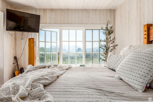 bedroom featuring wooden walls