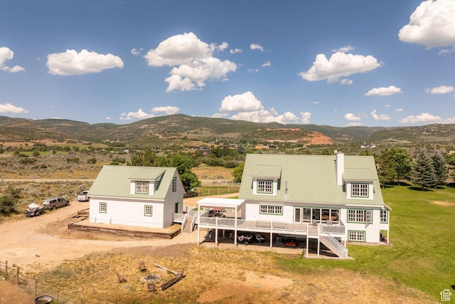 1380 S Mills Ln, Heber City, UT 84032 - rear view of house featuring a deck with mountain view, stairway, a chimney, metal roof, and a yard