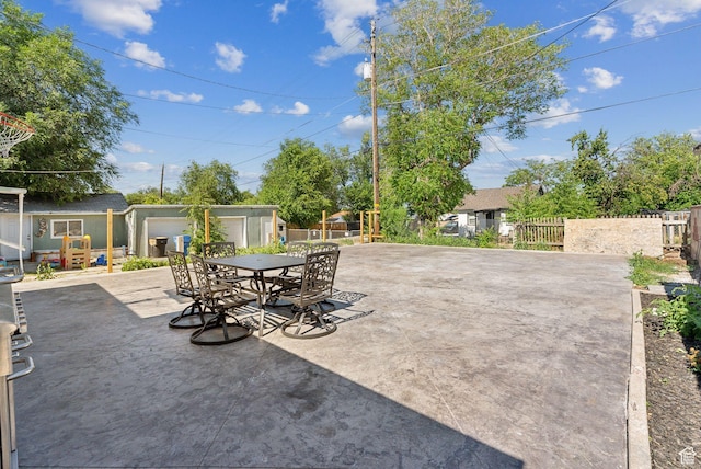 2977 S 8950 W, Magna, UT 84044 - view of patio with a garage and an outbuilding