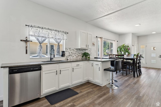 2977 S 8950 W, Magna, UT 84044 - kitchen featuring white cabinetry, sink, dark hardwood / wood-style flooring, stainless steel dishwasher, and kitchen peninsula