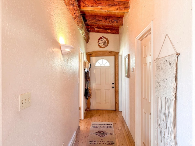 entryway featuring beam ceiling and light wood-type flooring