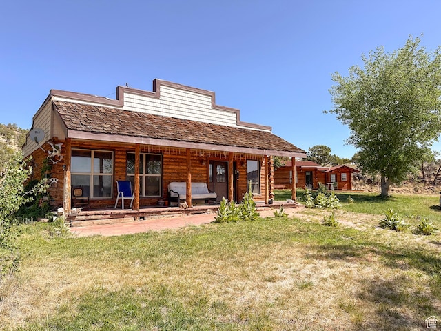 rear view of house with a yard