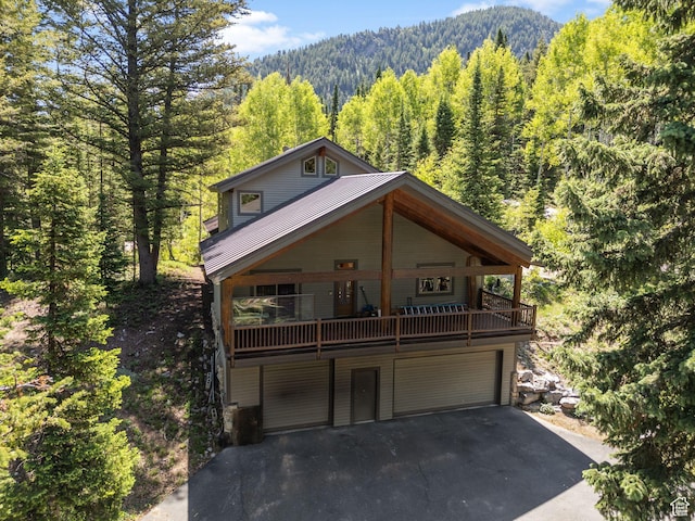 9443 E Wild Clematis Ln Unit 1, Brighton, UT 84121 - chalet / cabin featuring driveway, a view of trees, an attached garage, and a mountain view