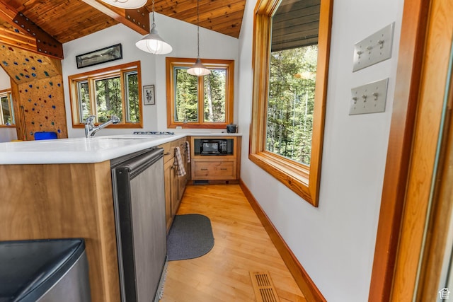 9443 E Wild Clematis Ln Unit 1, Brighton, UT 84121 - kitchen with vaulted ceiling, light countertops, dishwashing machine, and pendant lighting