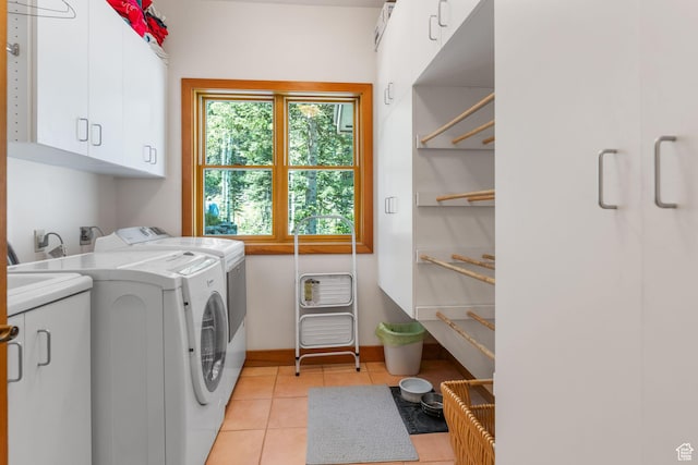 9443 E Wild Clematis Ln Unit 1, Brighton, UT 84121 - clothes washing area featuring washing machine and dryer, cabinet space, baseboards, and light tile patterned floors