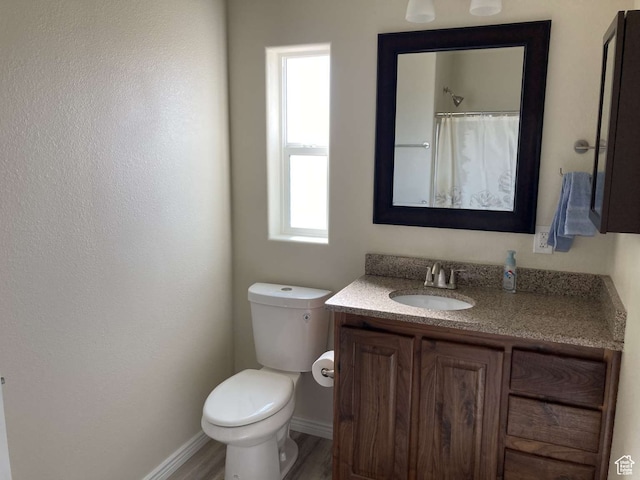 255 S 800 W, Escalante, UT 84726 - bathroom featuring a healthy amount of sunlight, vanity, toilet, and hardwood / wood-style flooring