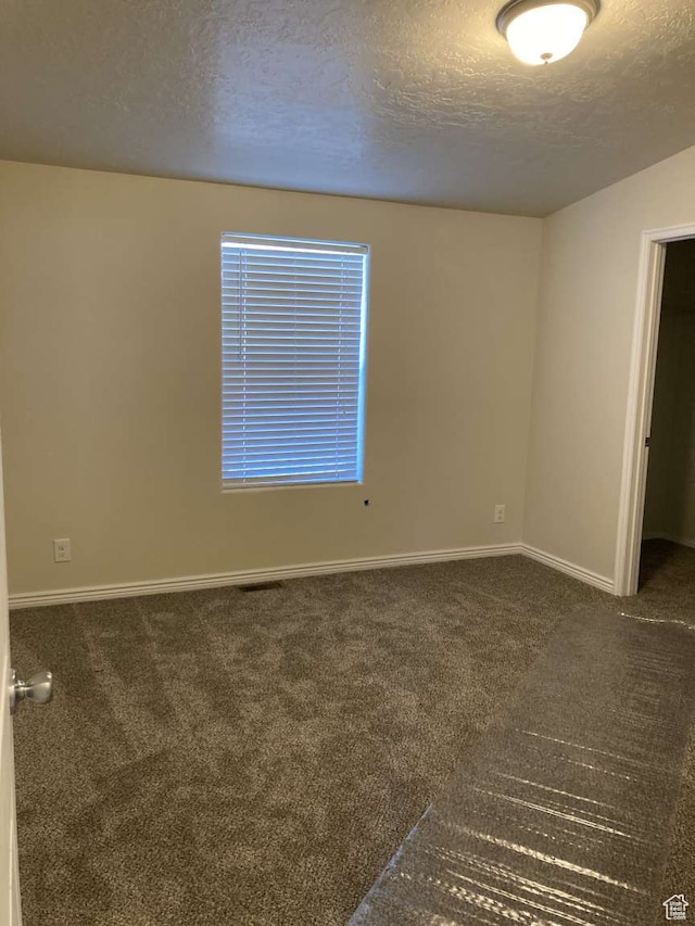 255 S 800 W, Escalante, UT 84726 - unfurnished room with a textured ceiling and dark carpet