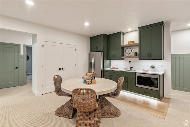 1901 S Sawmill Blvd E Unit 415, Heber City, UT 84032 - kitchen featuring built in microwave, sink, stainless steel refrigerator with ice dispenser, and green cabinetry