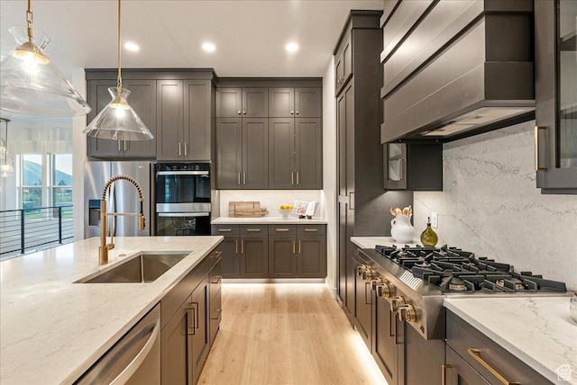 1901 S Sawmill Blvd E Unit 415, Heber City, UT 84032 - kitchen with pendant lighting, custom range hood, sink, and appliances with stainless steel finishes