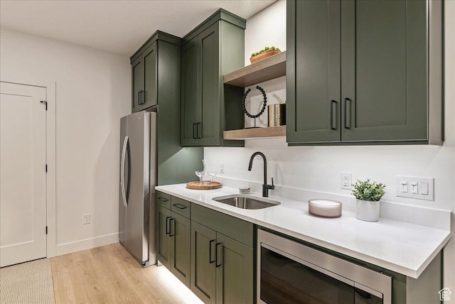 1901 S Sawmill Blvd E Unit 415, Heber City, UT 84032 - kitchen featuring green cabinets, sink, appliances with stainless steel finishes, and light hardwood / wood-style flooring