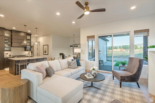 1901 S Sawmill Blvd E Unit 415, Heber City, UT 84032 - living room featuring ceiling fan, sink, and light wood-type flooring