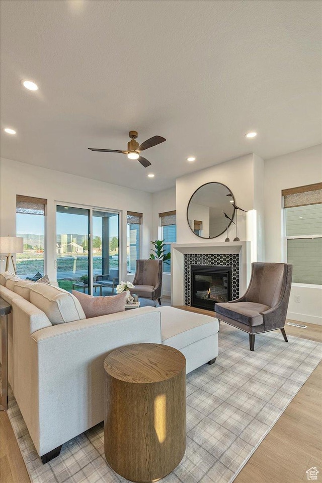 1901 S Sawmill Blvd E Unit 415, Heber City, UT 84032 - living room featuring a tile fireplace, ceiling fan, and light wood-type flooring