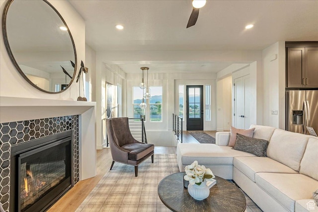 1901 S Sawmill Blvd E Unit 415, Heber City, UT 84032 - living room featuring ceiling fan, light hardwood / wood-style flooring, and a tiled fireplace