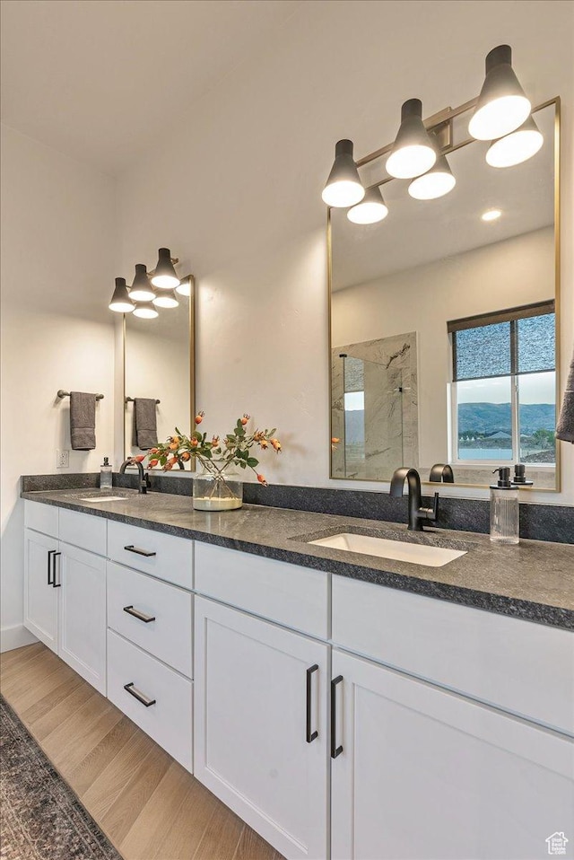 1901 S Sawmill Blvd E Unit 415, Heber City, UT 84032 - bathroom featuring vanity, a shower, and wood-type flooring