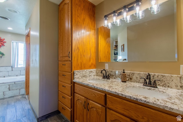 560 N 400 W, Smithfield, UT 84335 - full bath featuring wood finished floors, visible vents, a sink, and double vanity