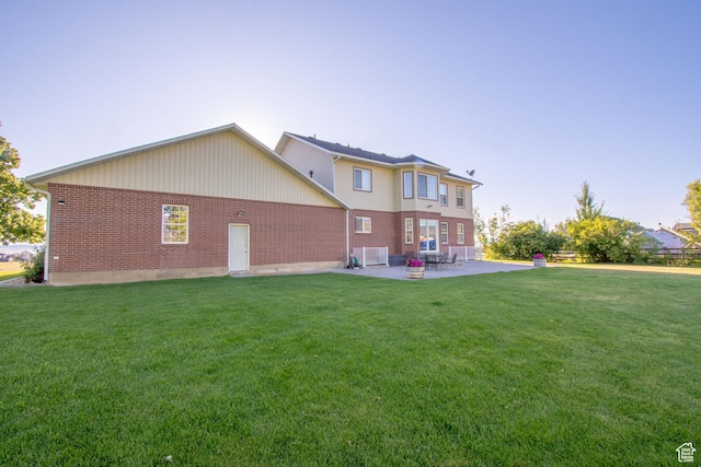 560 N 400 W, Smithfield, UT 84335 - back of house with a lawn, brick siding, and a patio area