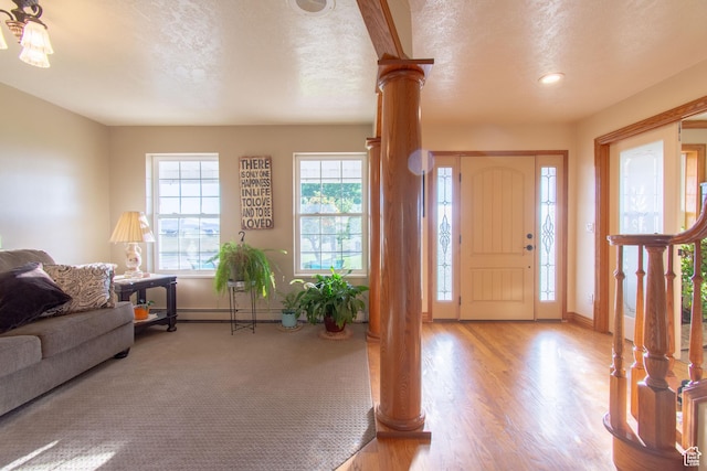 560 N 400 W, Smithfield, UT 84335 - entrance foyer with baseboard heating, baseboards, wood finished floors, and ornate columns